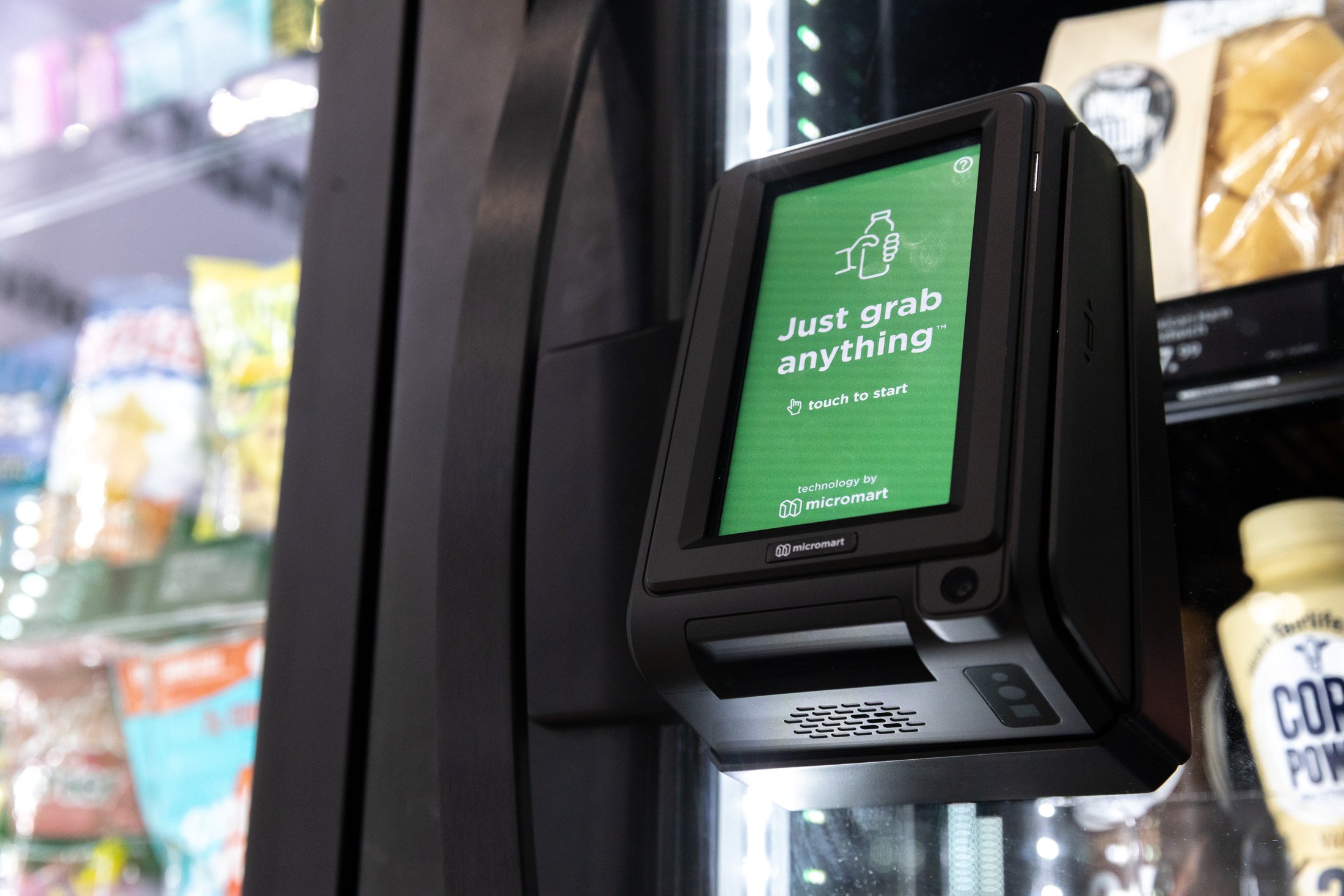 A resident tapping a card on the Smart Store reader